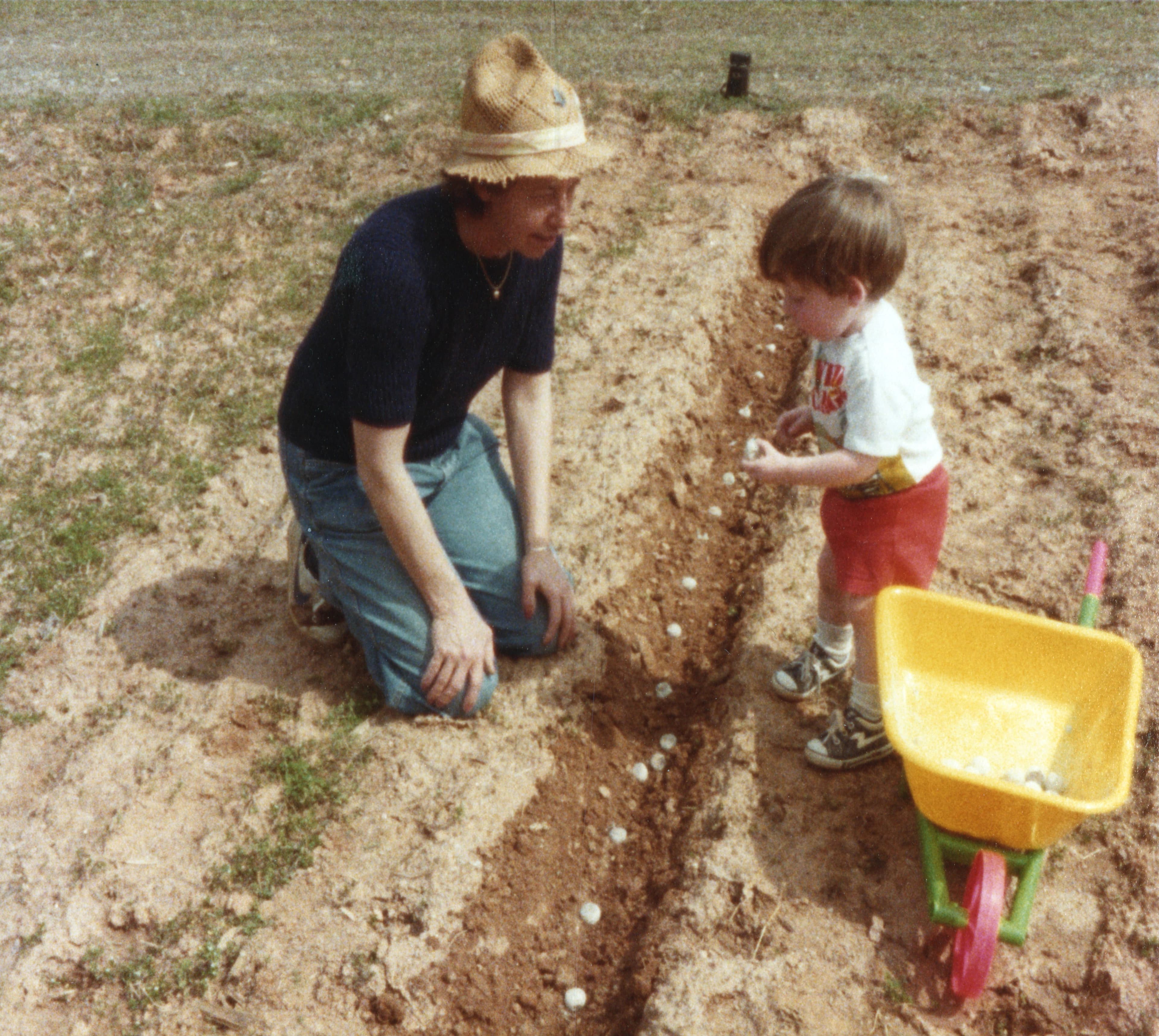 Childhood photo of a Pretty Hens founder planting bulbs with his father